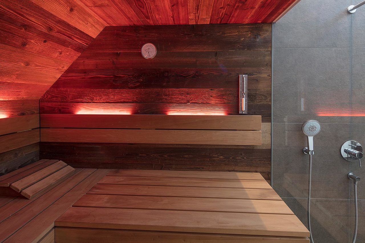 Altholz Sauna mit Dachschräge, direkt neben der Dusche. Dachschrägensauna.