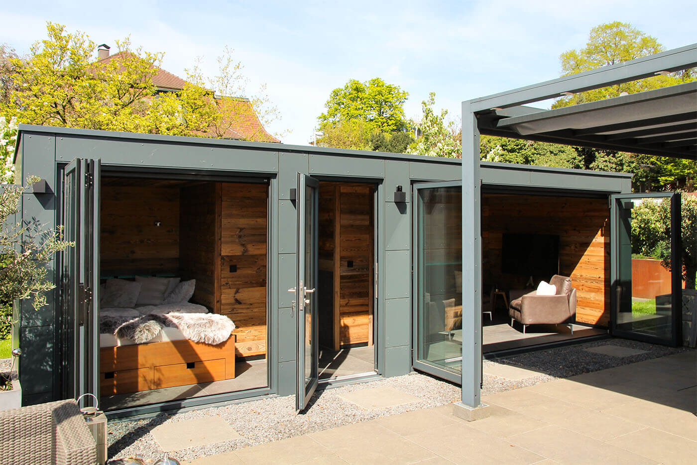 Custom-made pool house with opening glass front, daybed, coffee kitchen and lounge. Exterior cladding in weatherproof Trespa laminate panels.