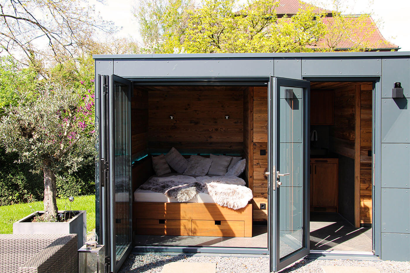 Custom-made pool house with opening glass front, daybed, coffee kitchen and lounge. Exterior cladding in weatherproof Trespa laminate panels.